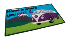Doormat with a purple van and text 'Home is where you park it.' on a white background