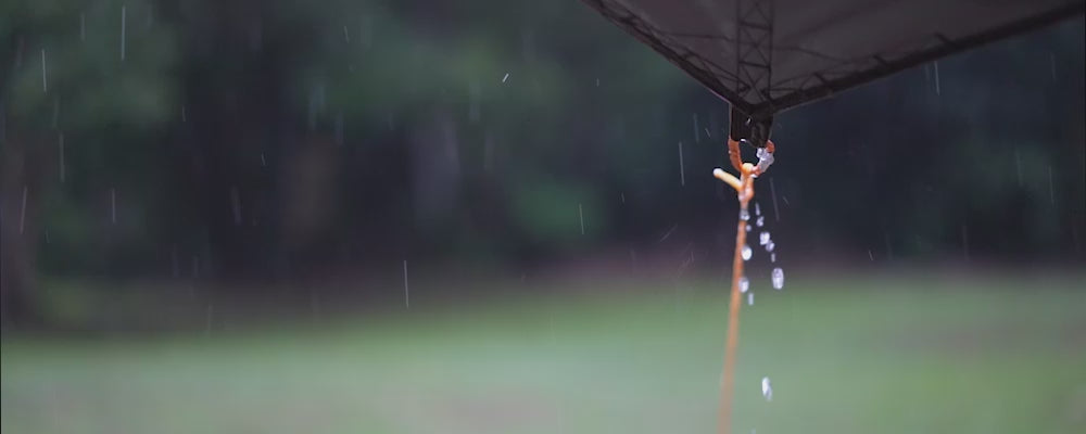 Load video: video of rain falling on a tent shelter