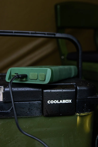 Green portable power bank charging COOLABOX cooler for camping adventures